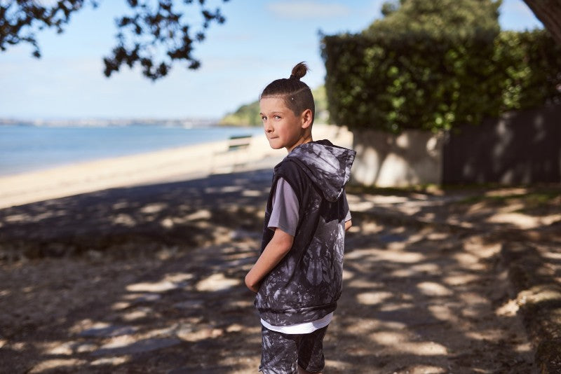 Cotton / spandex terry sleeveless hood in black tie-dye. Radicool Dude badge on chest & bolt print in white on reverse shoulder. A great piece for layering on cooler days or throw on as is.  Fit is true to size.